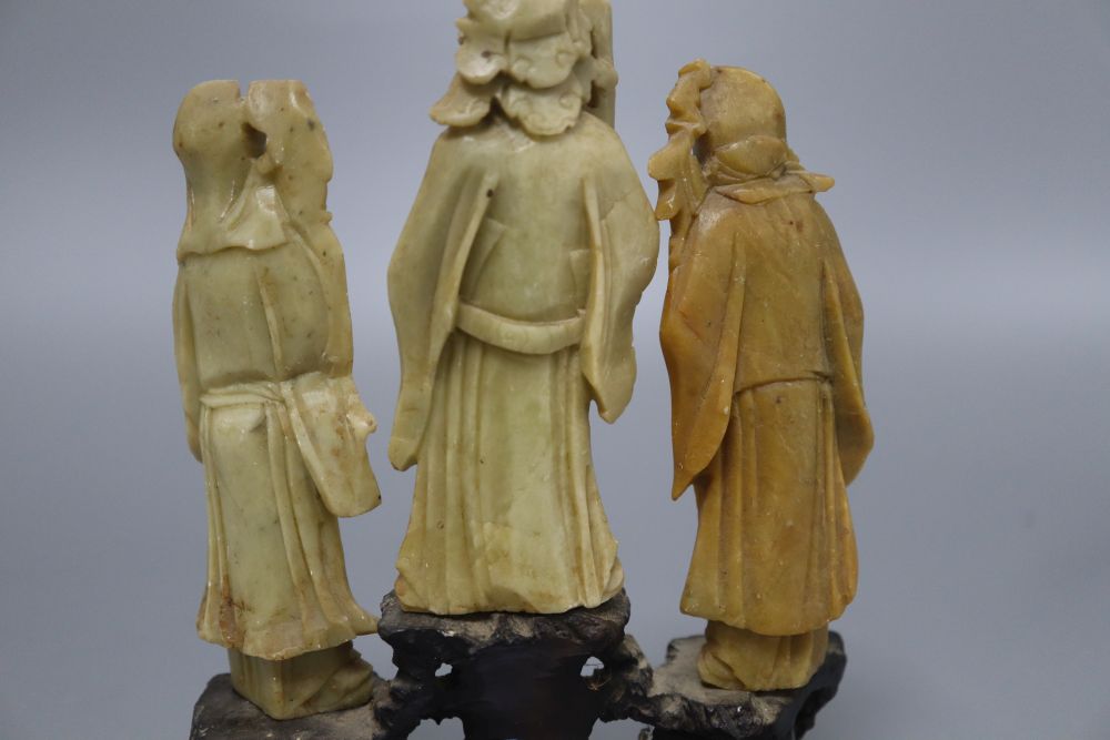 Three Chinese soapstone carvings of immortals, on base, height 19cm